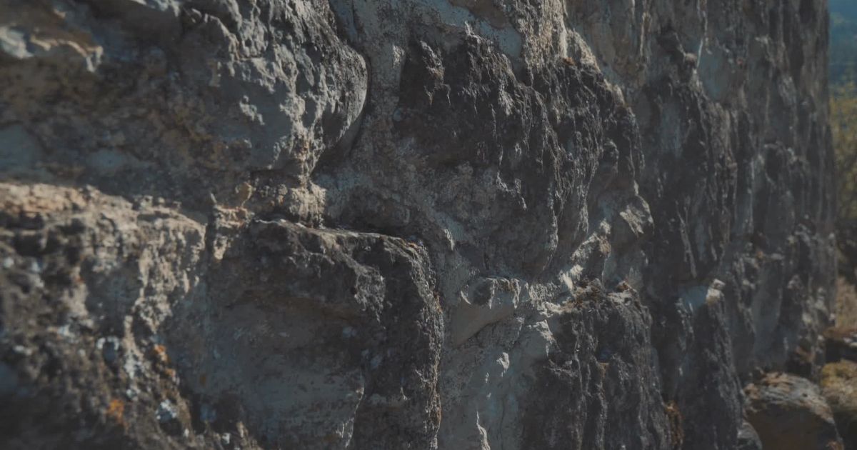 Slow light moving across a rough sandstone wall.